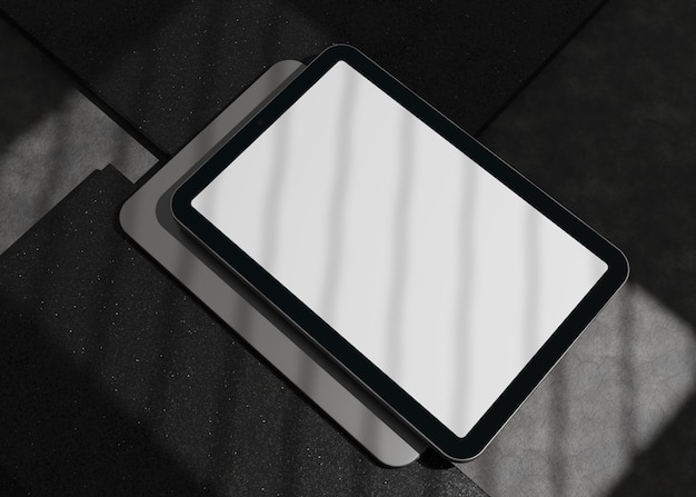 Tablet 3D computer with blank screen on concrete plaster background