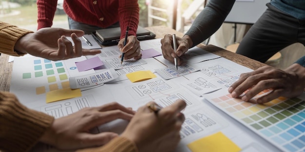 Team ux designer creative graphic planning application development a prototype smartphone layout