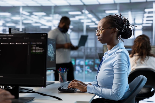 Technician in server room implementing power management solutions