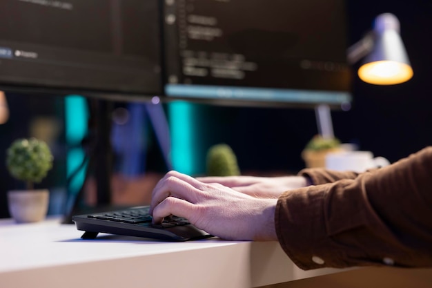 Teleworking system administrator typing on keyboard close up