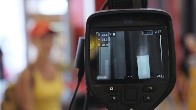 Temperature check at a supermarket grocery store with a thermal imaging camera installed Image monitoring scanner to monitor the body temperature