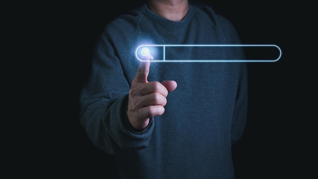 The concept of searching for information from the internet network show with the finger pointing to search bar website browser and search engine concept