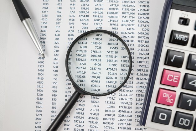 The concept of statistics financial analysis business economics Numbers on paper with accessories