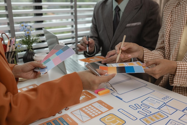 the development team is consulting on the design of the website UX UI they are working on project of ux ui interface innovation of ux ui develop team are discussing about their project