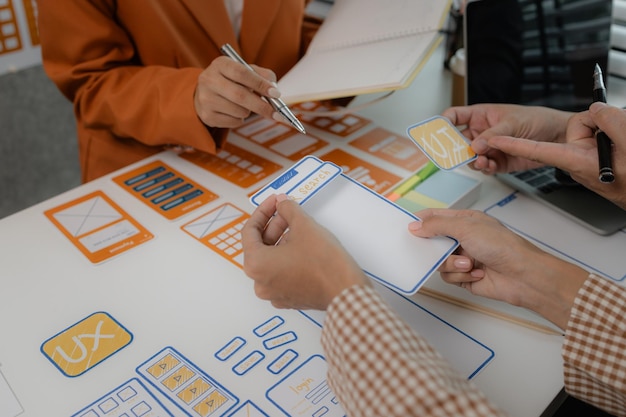 the development team is consulting on the design of the website UX UI they are working on project of ux ui interface innovation of ux ui develop team are discussing about their project