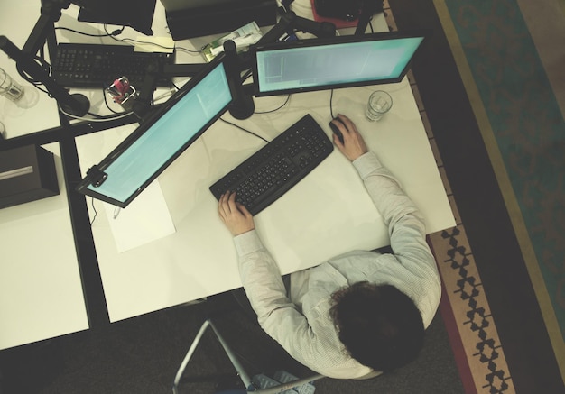 top view of software developer writing programming code on computer