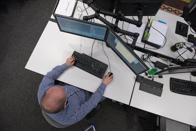 top view of software developer writing programming code on computer