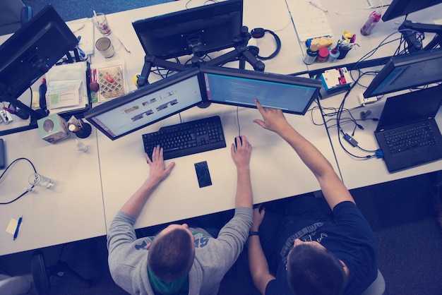top view of software developers writing programming code on computer