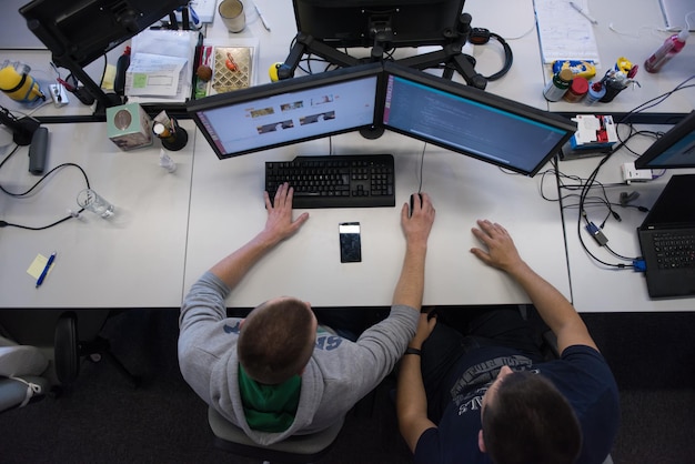 top view of software developers writing programming code on computer