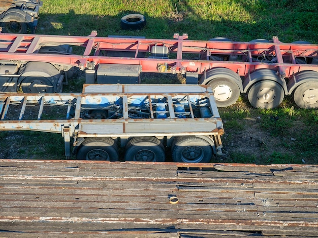 Trucks without trucks are parked Cars on the grass Unloaded trucks