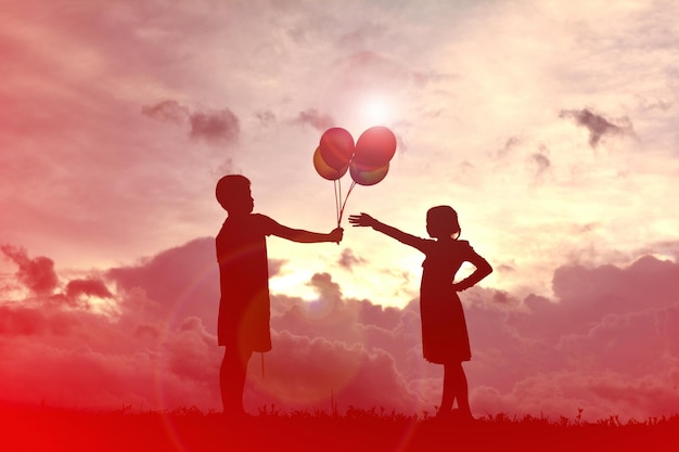 Two men with balloons against sky