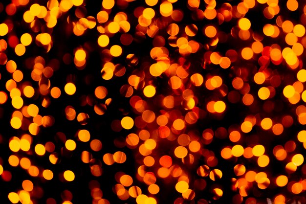Unfocused abstract gold bokeh on black background. 
