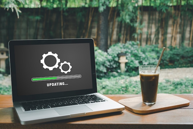 Update progress concept Person waiting for installing update process with loading bar icon on virtual screen on laptop computer