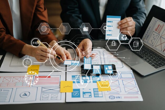 ux developer and ui designer brainstorming about mobile app interface wireframe design with customer breif and color code at modern office on virtual screen xa