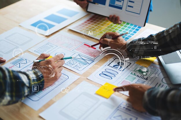 UX developer and ui designer brainstorming about mobile app interface wireframe design with customer breif and color code at modern office with virtual icon diagram