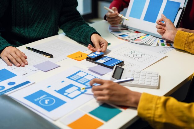 UX developer and ui designer brainstorming about mobile app interface wireframe design with customer breif and color code User experience concept