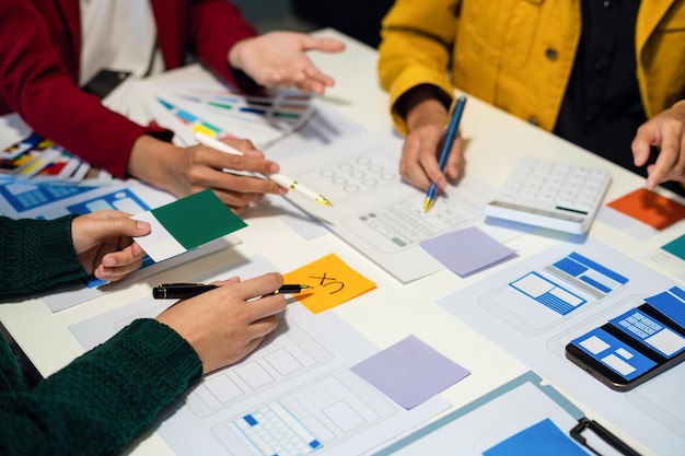 UX developer and ui designer brainstorming about mobile app interface wireframe design with customer breif and color code User experience concept