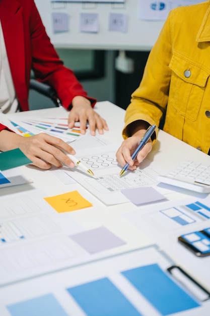 UX developer and ui designer brainstorming about mobile app interface wireframe design