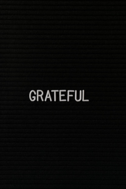 vertical black spongy board with a text grateful for background