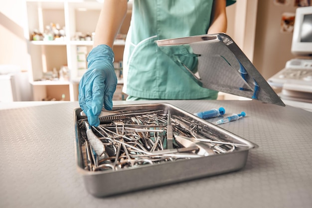 Vet tool kit photo of vet hands in protective gloves taking the necessary tool that