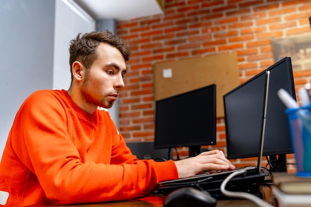 Web programmer near monitor at office in software development company Website design programming and coding technologies