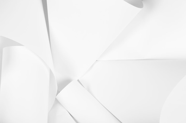 White sheets of office paper are twisted and scattered Paper white abstract background