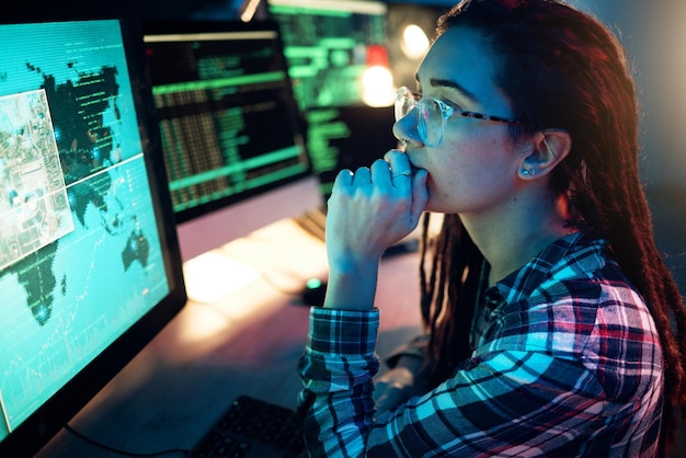 Woman computer screen and hacker thinking with software data programming or cybersecurity Idea coder and female reading map for hacking location or phishing info on dark web at night in home