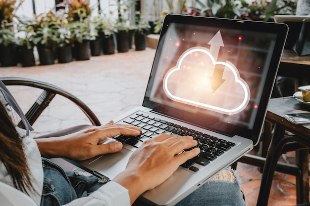 Woman hand using laptop computer with cloud computing icon Cloud computing concept Backup Storage Data Internet networking and digital Share global technology conceptx9