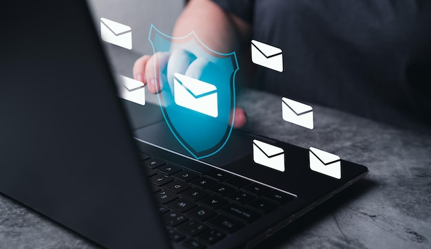 Woman use laptop with hologram interface of email security protection Internet network