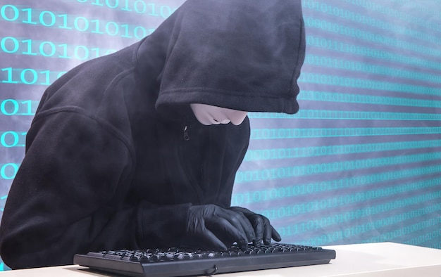woman wearing mask while typing on keyboard against binary background