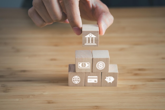 wooden block of financial with money and bank iconsbusiness financial and money saving concept