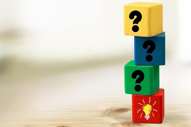 Wooden cube block with light bulb icon and question mark symbol