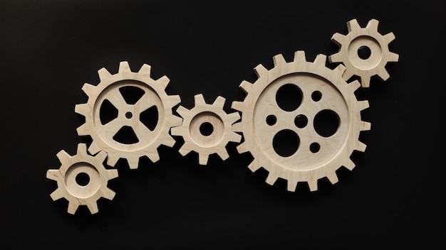 Wooden mechanisms on a black background black chalk board