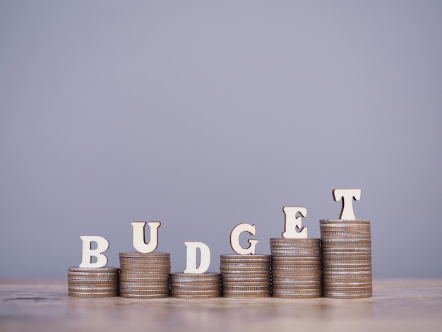 Wooden words with the BUDGET on stack of coins The concept about budget planning and allocation