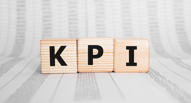 Word KPI made with wood building blocks, business concept.