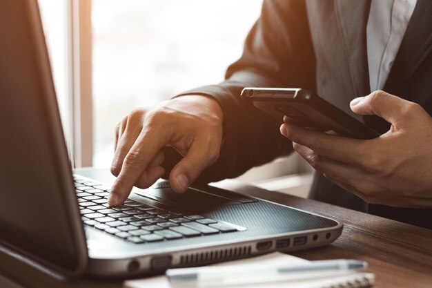 Work using mobile phone typing computer mobile chat laptop contact us at workplaces planning ideas investors internet searching ideas connecting people