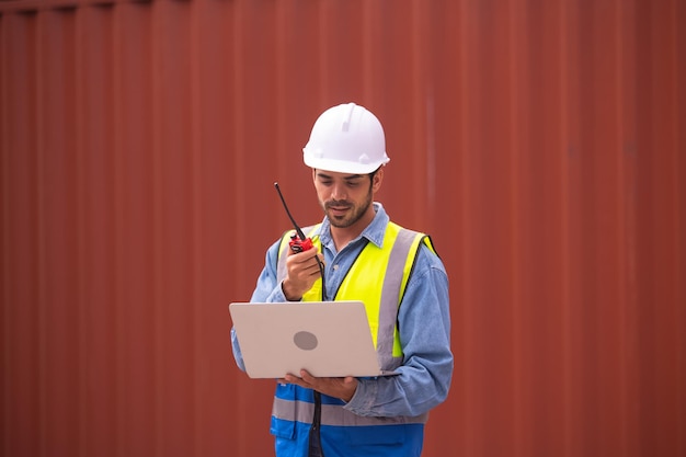 Worker using computer in containers export background Engineer using computer in containers import background