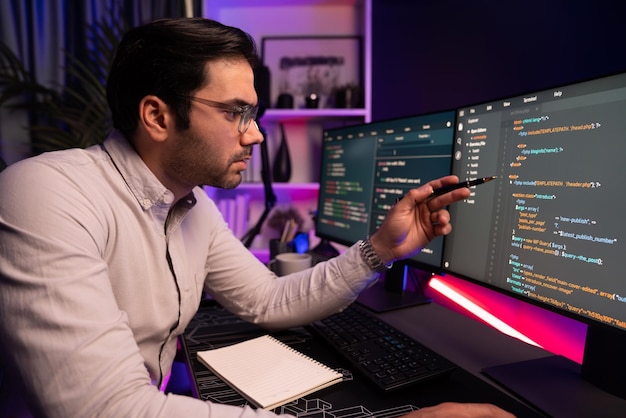 Working smart IT developer pointing data software development on pc Surmise