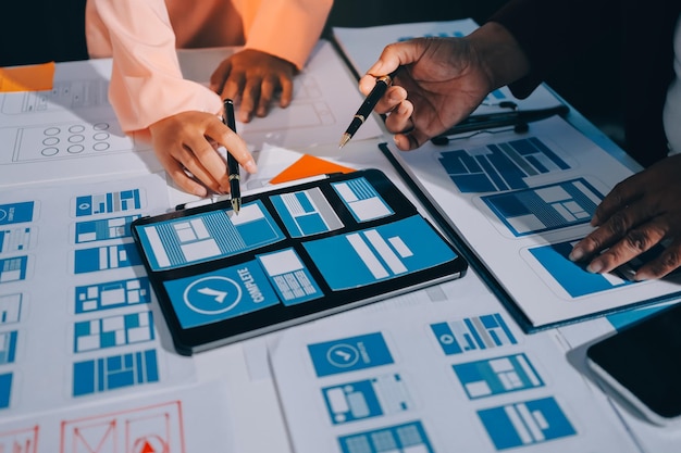 young asian business creative team work together mobile application software design project brainstorm meeting internet technology smartphone web app designer office coworker teamwork concept