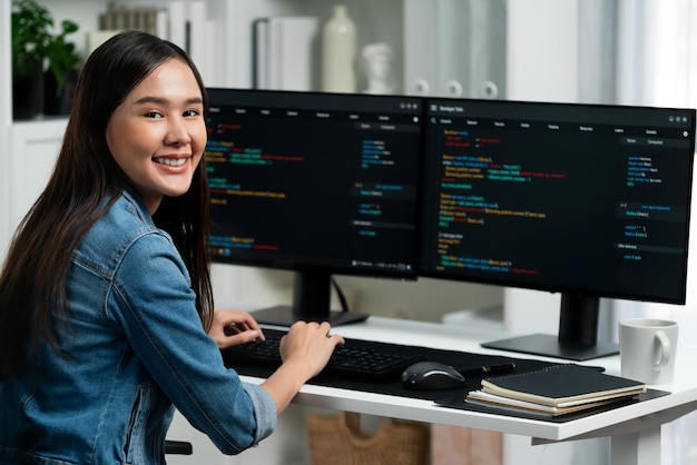 Young Asian in IT developer looking at camera to present on pc Stratagem