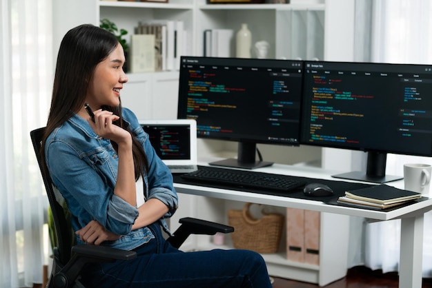 Young Asian in IT developer looking online information on pc to pose Stratagem