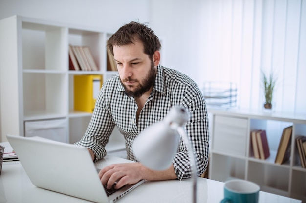 Young man using a laptop indoors