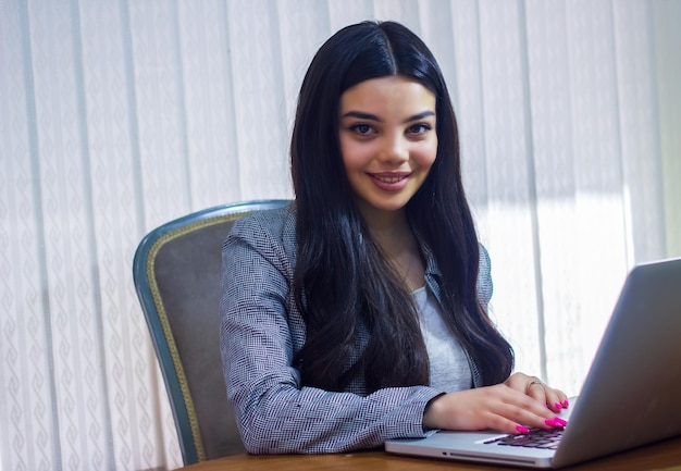 young woman working on laptop businesswoman working on laptop in office young businesswoman