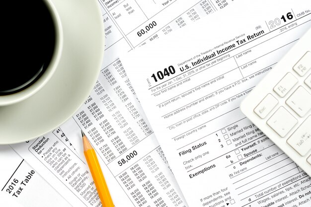 00 tax forms top view with coffee cup and pencil
