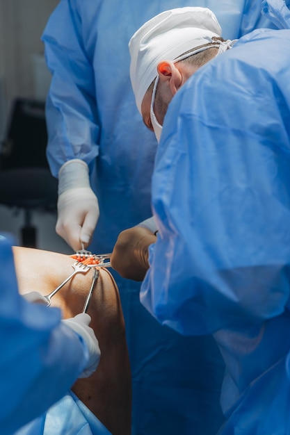 02012024 Vinnytsia Ukraine two trauma surgeons work on a patients knee joint reconstruction on the operating table