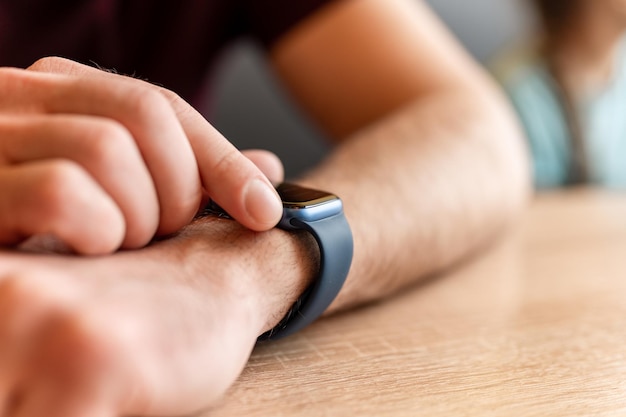 02232022 Moscow male hand with a wrist smart apple watch young man people using modern technology by adjusting and setting the time on the clock by touching the digital screen with his fingers