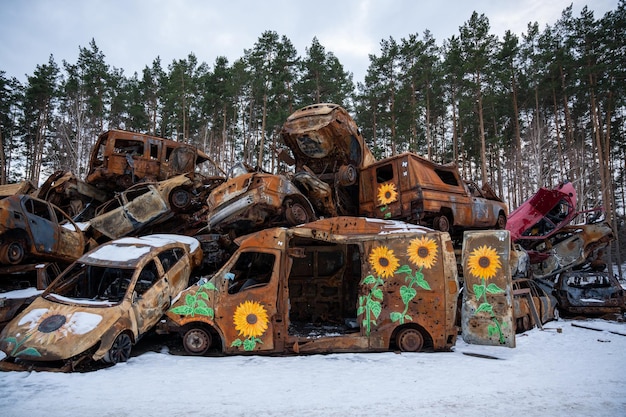 03022023 Irpin Ukraine Stacked a bunch of crashed cars after fire and missiles attacks in town with art on them