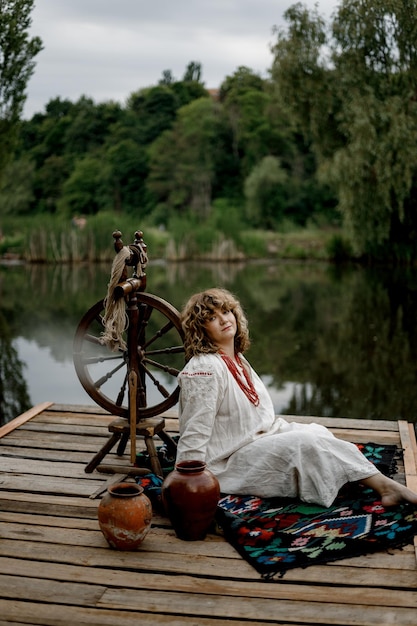 040622 Vinnitsa Ukraine a woman posing for a photo is dressed in national Ukrainian clothes against the background of the river