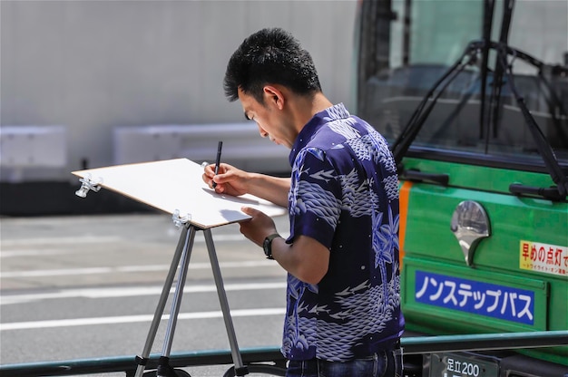 사진 2015년 5월 16일 일본 도쿄에서 일본인 남자가 낮에 도쿄역 입구의 그림을 그렸다.