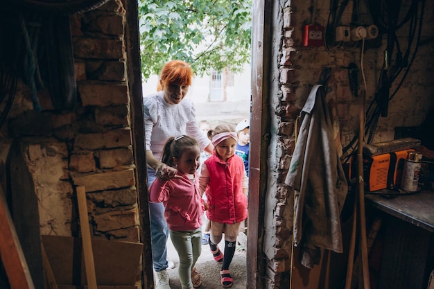 070722 Irpin Ukraine small children and their caregivers are evacuated to an underground cellar used as a shelter during an air raid